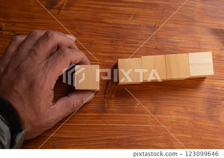 Person holding a blank wooden block 123099646