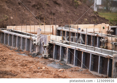 Construction of pile-grillage foundation. Monolithic foundation with metal reinforcement. Monolithic concrete foundation. House construction 123099916