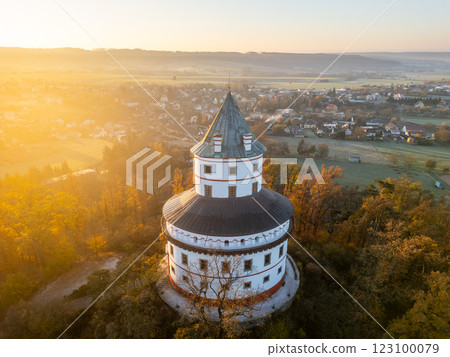 The Humprecht chateau stands majestically above Sobotka, bathed in the warm glow of an autumn sunrise, overlooking the colorful landscape of the Bohemian Paradise. 123100079