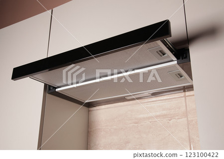 Modern Range Hood. Cooking Hood. Kitchen with Modern interior light beige color, Household Appliances. Cooking food at Home Modern Range Hood. Cooking Hood. Kitchen with Modern interior light beige color, Household Appliances. Cooking food at Home 123100422