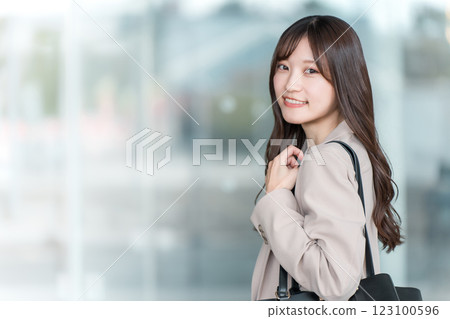 Young Asian businesswoman walking in an office area in the city 123100596