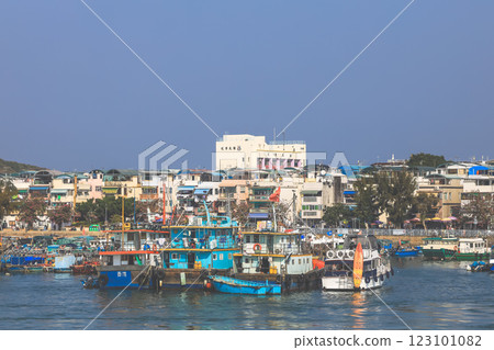 Dec 28 2024 Coastal Town Harbor Scene with Docked Boats and Waterfront Shops 123101082