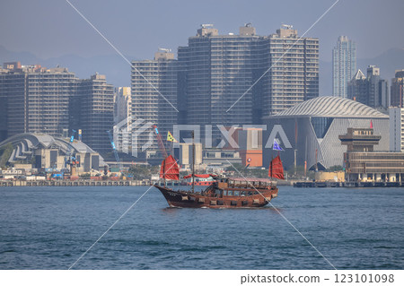 Dec 28 2024 Traditional Chinese Junk Boat Sailing in Front of Modern City, hk 123101098