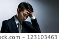 A businessman in a suit worried with his hand on his forehead 123103463