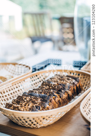 Close-up of homemade artisan bread slices arranged in wicker baskets, highlighting fresh baking, cozy kitchen vibes, and rustic food styling Close-up of homemade artisan bread slices arranged in wicker baskets, highlighting fresh baking, cozy kitchen vibes, and rustic food styling 123104260