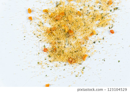 Scattered all-purpose seasoning from a mixture of vegetables and salt on a white background Scattered all-purpose seasoning from a mixture of vegetables and salt on a white background 123104529