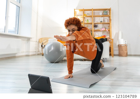 Fitness Workout training. Young healthy fit African girl doing sports exercise on yoga mat on floor at home. Athletic woman in sportswear have training workout for weight loss. Sport and fitness 123104789