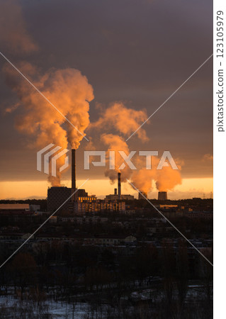 A thermal power plant in the distance at dawn. Smoke illuminated by sunlight 123105979