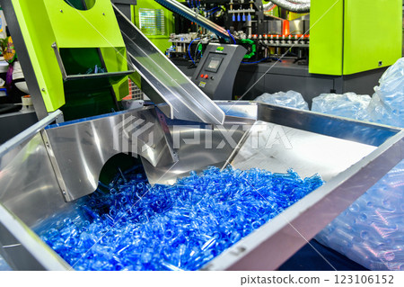 Blue Plastic bottles in production line at manufacturing PET bottle perform, before bottles blowing in blowing machine at drink water factory. 123106152