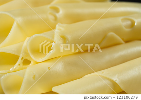 Semi-hard cheese, thin slices, rolled into tubes. Semi-hard cheese, thin slices, rolled into tubes. 123106279