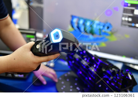 Portable 3D car-shaped handheld scanner is scanning to measure size and texture for future product development production in the automotive industry 123106361