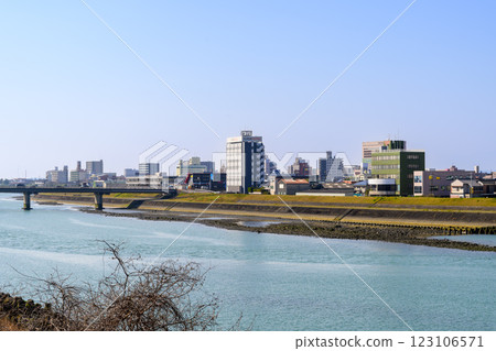 The view of Yatsushiro City from the Shinmaekawa Weir, a diversion weir of the Kuma River, against the blue sky The view of Yatsushiro City from the Shinmaekawa Weir, a diversion weir of the Kuma River, against the blue sky 123106571