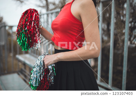 Cheerleader Girl Cheers Her Heart Team With Pompon In Football Stadium Cheerleader Girl Cheers Her Heart Team With Pompon In Football Stadium 123107403