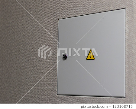 Close up shot of the door to the electric switchboard in the wall of the apartment. Indoors 123108715