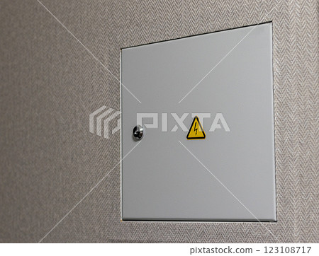 Close up shot of the door to the electric switchboard in the wall of the apartment. Indoors 123108717