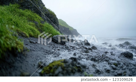 Washed-out coastal scene with rocky cliffs, muted blues and grays, overcast cinematic mood Washed-out coastal scene with rocky cliffs, muted blues and grays, overcast cinematic mood 123109026