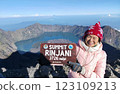Asian middle-aged woman at the top of Mount Rinjani,Lombok,Indonesia. 123109213