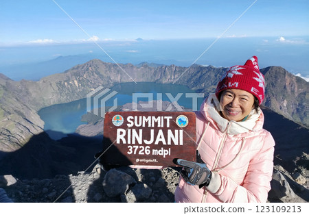 Asian middle-aged woman at the top of Mount Rinjani,Lombok,Indonesia. 123109213