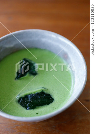 Cup of fresh matcha tea, green tea on wooden table Cup of fresh matcha tea, green tea on wooden table 123110089