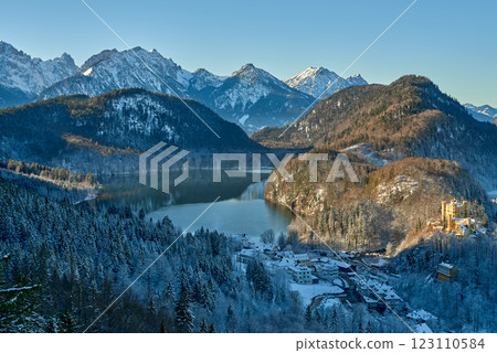 Serene Winter Scene with Snow-Covered Tree Branch, Charming Two-Story Building with Blue Roof, Medieval Castle, and Golden Light, Peaceful European Setting, Perfect for Travel and Historical Themes Serene Winter Scene with Snow-Covered Tree Branch, Charming Two-Story Building with Blue Roof, Medieval Castle, and Golden Light, Peaceful European Setting, Perfect for Travel and Historical Themes 123110584