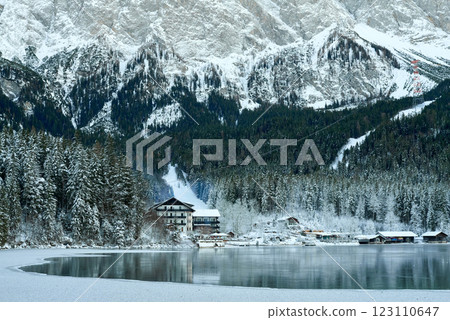 Picturesque Winter Village in Bavarian Alps: Eibsee Lake and Zugspitze Mountain Panorama with Snow-Covered Chalets and Ski Resort Picturesque Winter Village in Bavarian Alps: Eibsee Lake and Zugspitze Mountain Panorama with Snow-Covered Chalets and Ski Resort 123110647