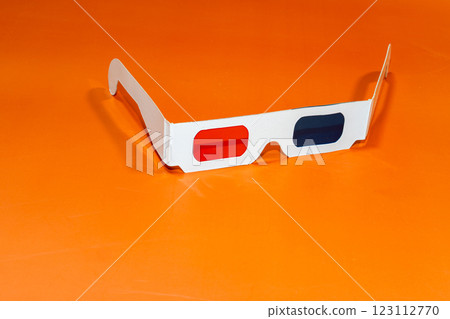 Glasses for seeing 3D in the cinema on an orange surface 123112770
