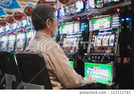 Man playing slot machine Man playing slot machine 123112781