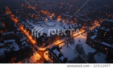A stunning aerial view of a snow-covered urban landscape at twilight. The scene captures warm streetlights illuminating the quiet streets below. Generative AI. A stunning aerial view of a snow-covered urban landscape at twilight. The scene captures warm streetlights illuminating the quiet streets below. Generative AI. 123112977