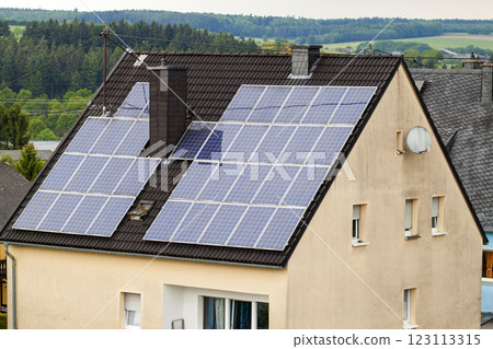 Renewable clean green energy saving efficient solar panels on suburban house roof. Renewable clean green energy saving efficient solar panels on suburban house roof. 123113315