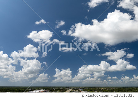 Rain clouds forming on blue sky over rural Florida town. Colorful summer skyscape 123113323
