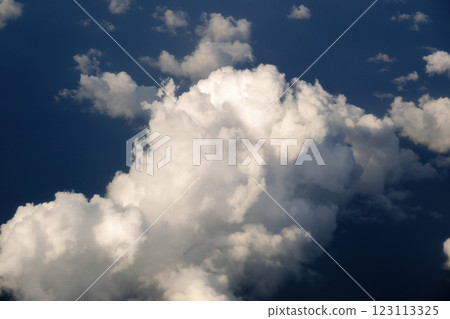 Rain clouds forming at high altitude. View from plane window at high altitude of sky. Air travel concept Rain clouds forming at high altitude. View from plane window at high altitude of sky. Air travel concept 123113325