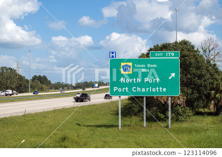 Interstate freeway exit sign in Florida, USA. I-75 highway interchange with direction to North Port and Port Charlotte Interstate freeway exit sign in Florida, USA. I-75 highway interchange with direction to North Port and Port Charlotte 123114096