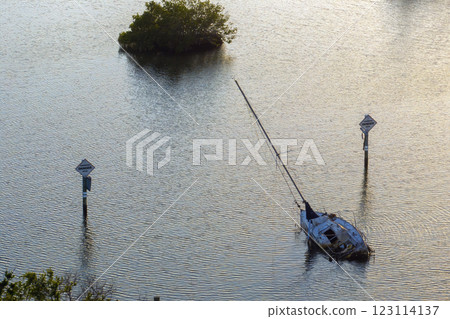 Half sunken sailing yacht capsized on shallow bay waters after hurricane Ian in Manasota, Florida Half sunken sailing yacht capsized on shallow bay waters after hurricane Ian in Manasota, Florida 123114137