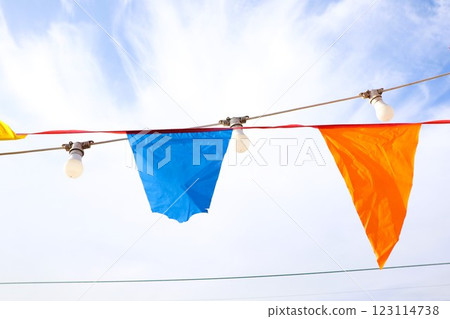 Vibrant and colorful bunting flags hang joyfully against a bright and radiant sky 123114738
