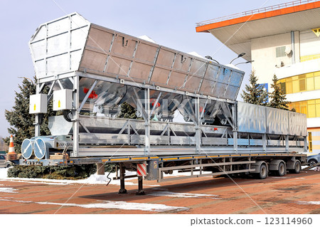 Large transport trailer with hoppers and red vibrators and shakers for ready-mix concrete mixing plants. 123114960