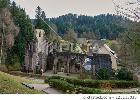 Enchanting Ruins of Medieval Monastery Nestled in Black Forest Germany Scenic Landscape. Ancient Gothic Stone Architecture Surrounded by Lush Nature and Historic Houses Showcases Timeless Beauty 123115036