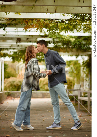 Young Cute Female Hugs Boyfriend. In Autumn Outdoor. Lovers Walking in Park. Attractive Funny Couple. Lovestory in Forest. Man and Woman. Cute Lovers in the Park. Family Concept. Happy Couple. 123115047
