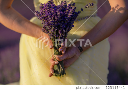 woman poses in lavender field at sunset. Happy woman in yellow dress holds lavender bouquet. Aromatherapy concept, lavender oil, photo session in lavender woman poses in lavender field at sunset. Happy woman in yellow dress holds lavender bouquet. Aromatherapy concept, lavender oil, photo session in lavender 123115441