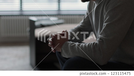 Man sitting on sofa at home, unhappy upset thinking suffering from relationships problems. Relationship crisis. Man sitting on sofa at home, unhappy upset thinking suffering from relationships problems. Relationship crisis. 123115475