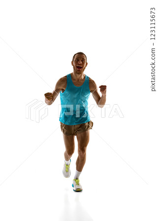 Athlete running with triumphant energy, clenched fists and ecstatic face symbolizing dedication against white studio background. Athlete running with triumphant energy, clenched fists and ecstatic face symbolizing dedication against white studio background. 123115673
