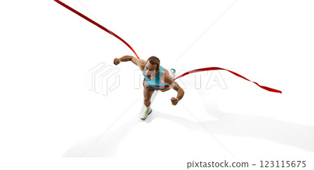 Sprinter breaking red ribbon, clenched fists and with determined face capturing final moment of race against white studio background. Sprinter breaking red ribbon, clenched fists and with determined face capturing final moment of race against white studio background. 123115675