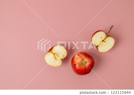 Red apple, half apple and quarter apple on pink background. Top view, healthy food concept. Top view. Red apple, half apple and quarter apple on pink background. Top view, healthy food concept. Top view. 123115844