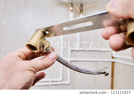 Stainless steel braided flexible hose with loose nut female ends with rubber washers on either ends connect to pipework. 123115857