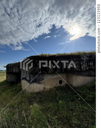 Old concrete bunker under a dramatic cloudy sky Old concrete bunker under a dramatic cloudy sky 123115958