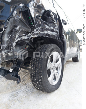 Severely Damaged Car After an Accident on a Snowy Road 123116196