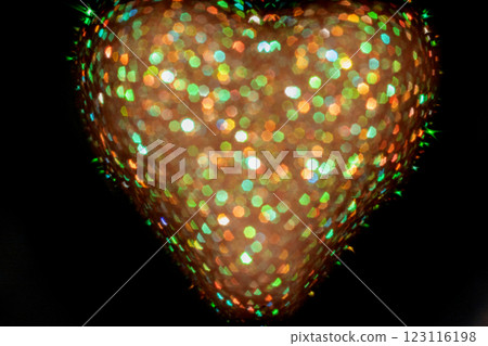 Colorful heart-shaped bokeh in a dark background creating vibrant light patterns Colorful heart-shaped bokeh in a dark background creating vibrant light patterns 123116198