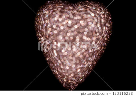 Heart-shaped holiday lights with glowing bokeh effect on dark background Heart-shaped holiday lights with glowing bokeh effect on dark background 123116258
