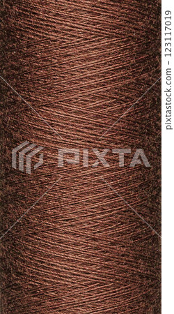 macro texture of a skein of brown sewing thread 123117019