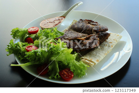 Restaurant serving baked steak with salad and cocktail tomatoes Restaurant serving baked steak with salad and cocktail tomatoes 123117349