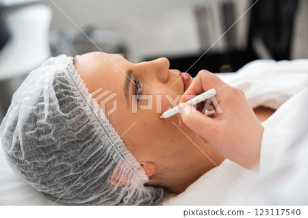 Beauty treatment in a spa featuring a woman getting facial care Beauty treatment in a spa featuring a woman getting facial care 123117540